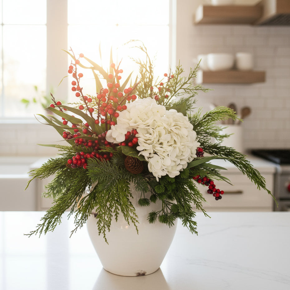 Floral arrangement with white flowers, red berries, and greenery on a light background