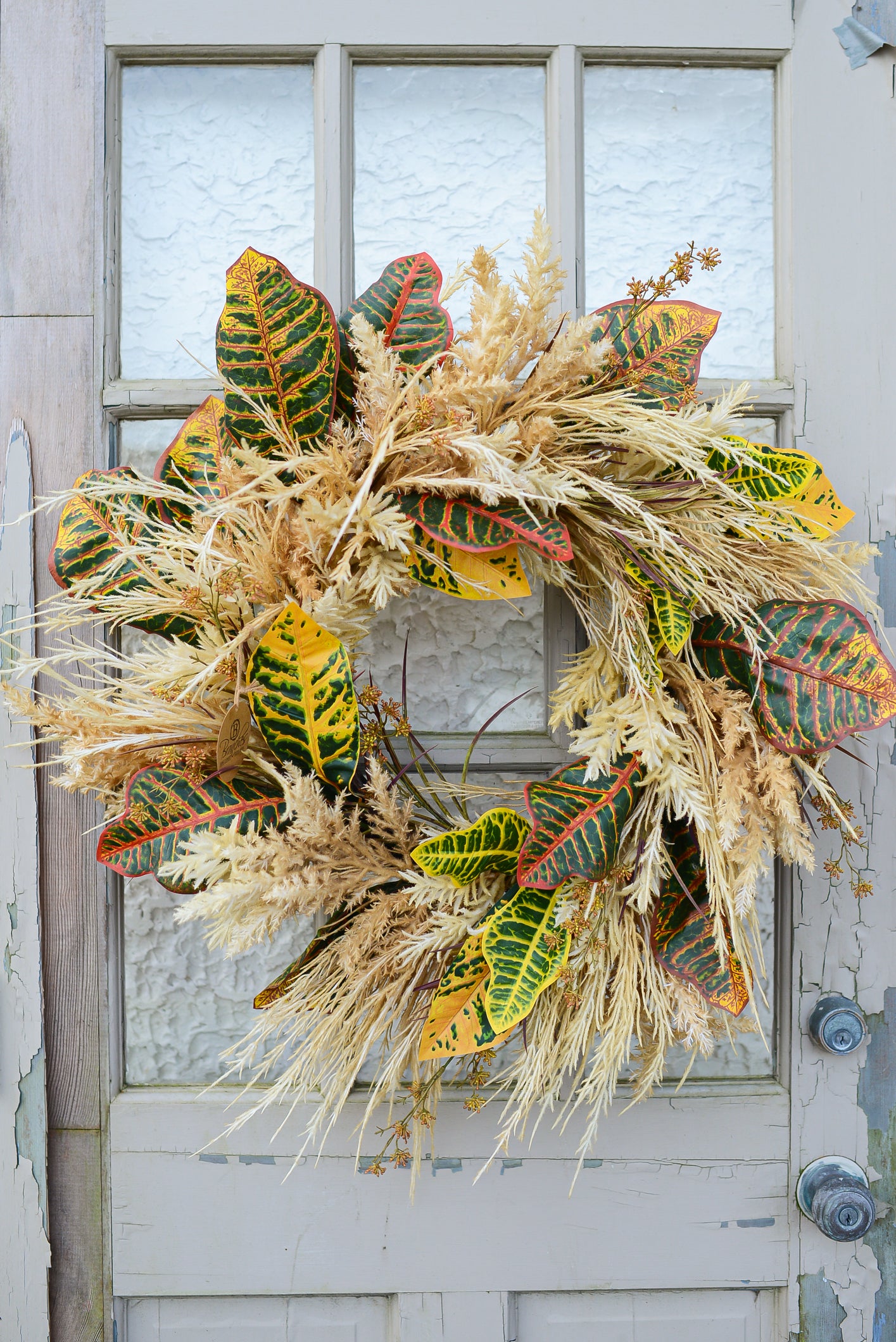 Decorative wreath with autumn leaves on a door
