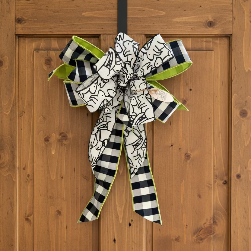 Decorative bow with black, white, and green pattern on a wooden surface