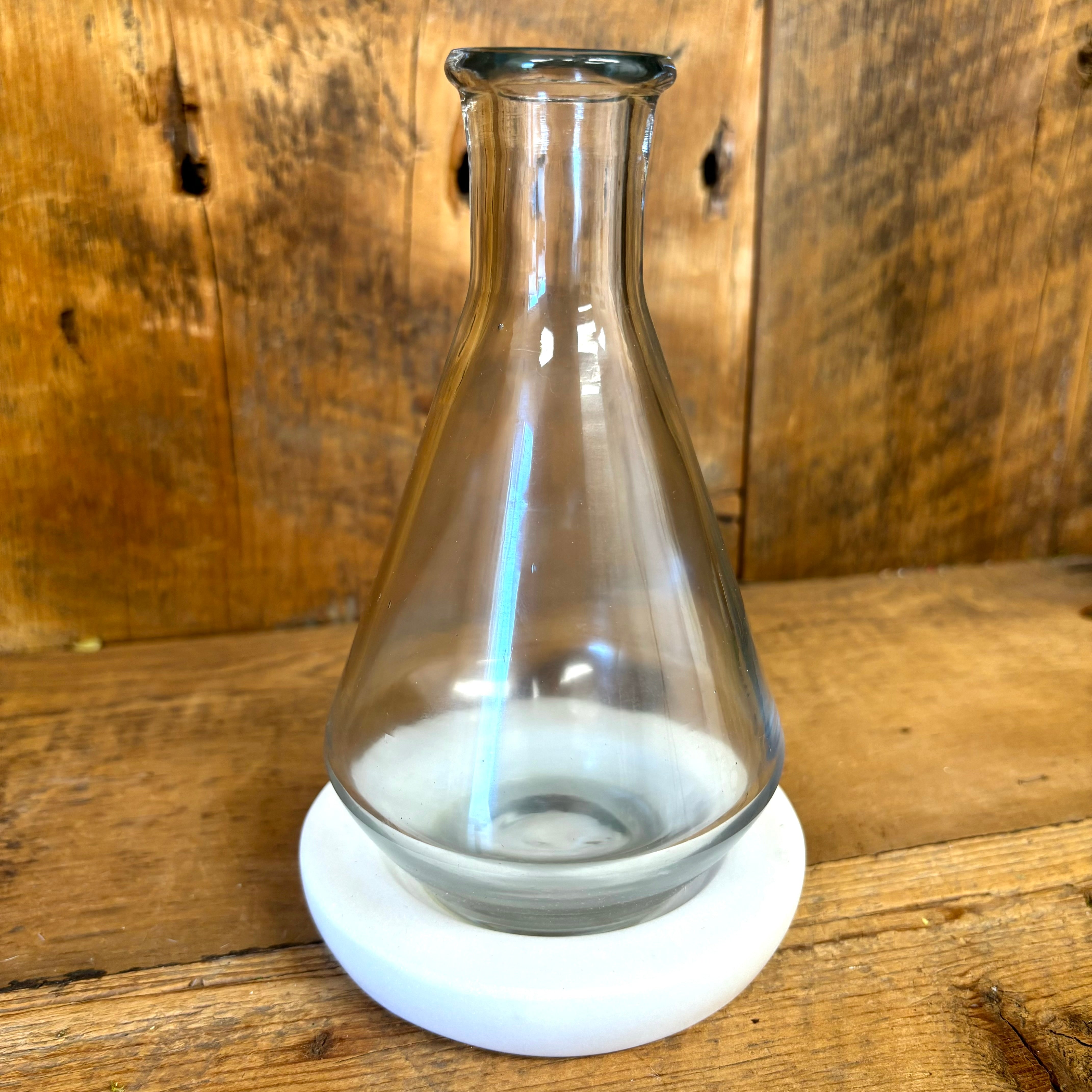 Clear Glass Flask Vase on White Marble Base